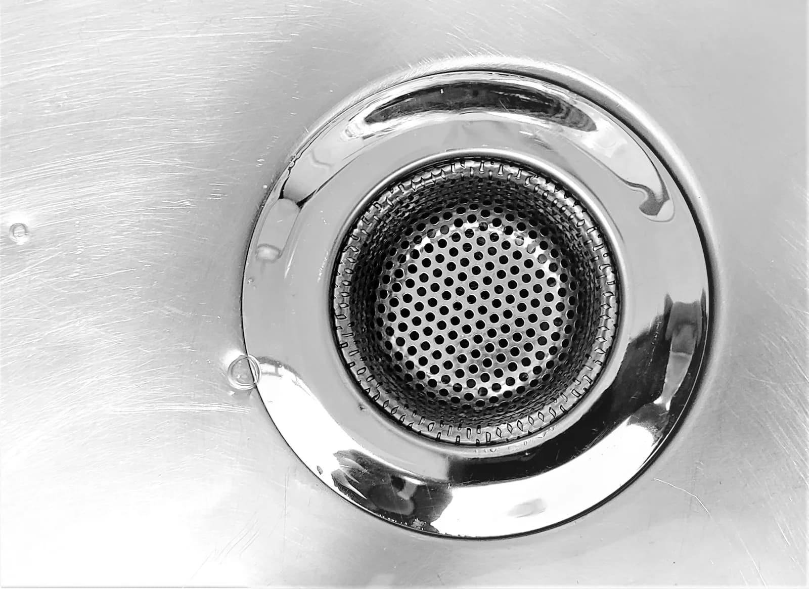 A clean steel sink drain up close