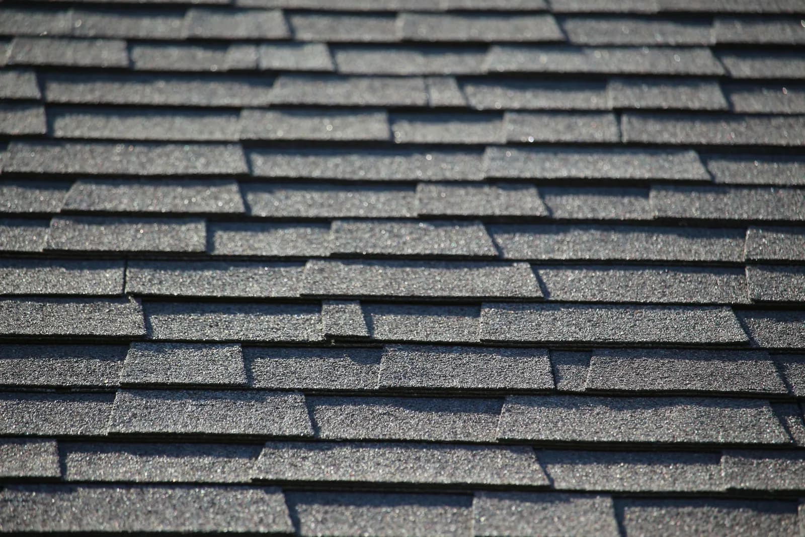 Rows of gray shingles on a roof, up close