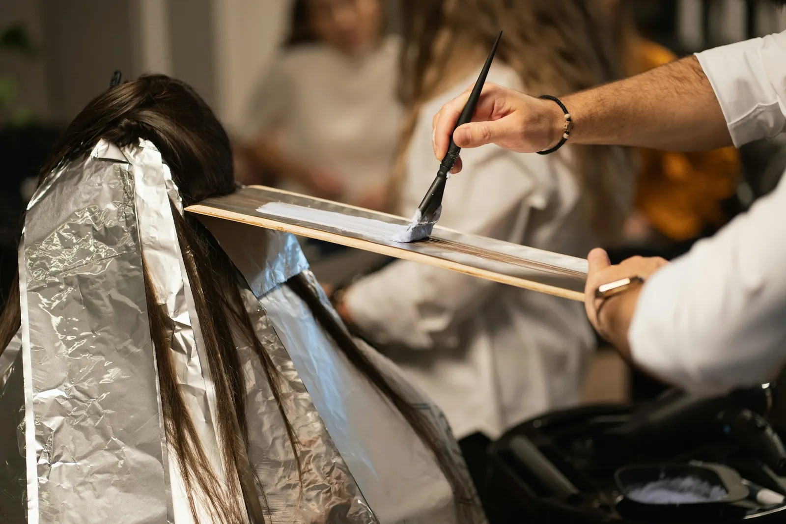 A colorist paints highlights on foil