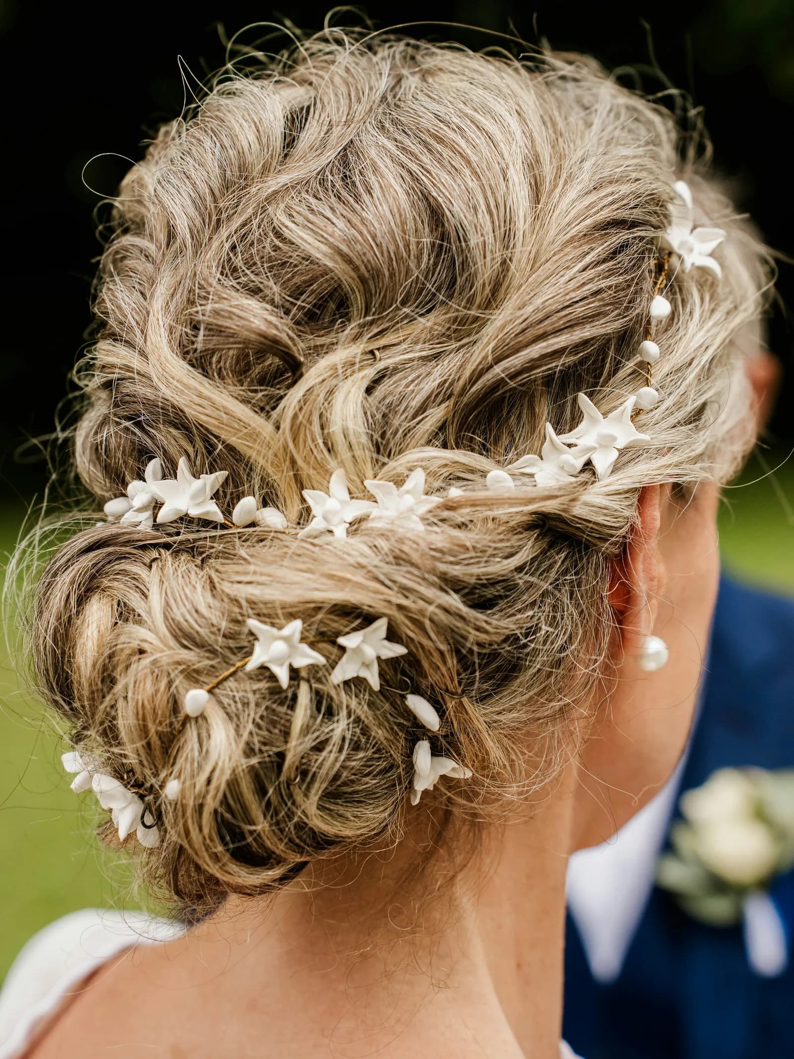 A soft updo with small white star pins